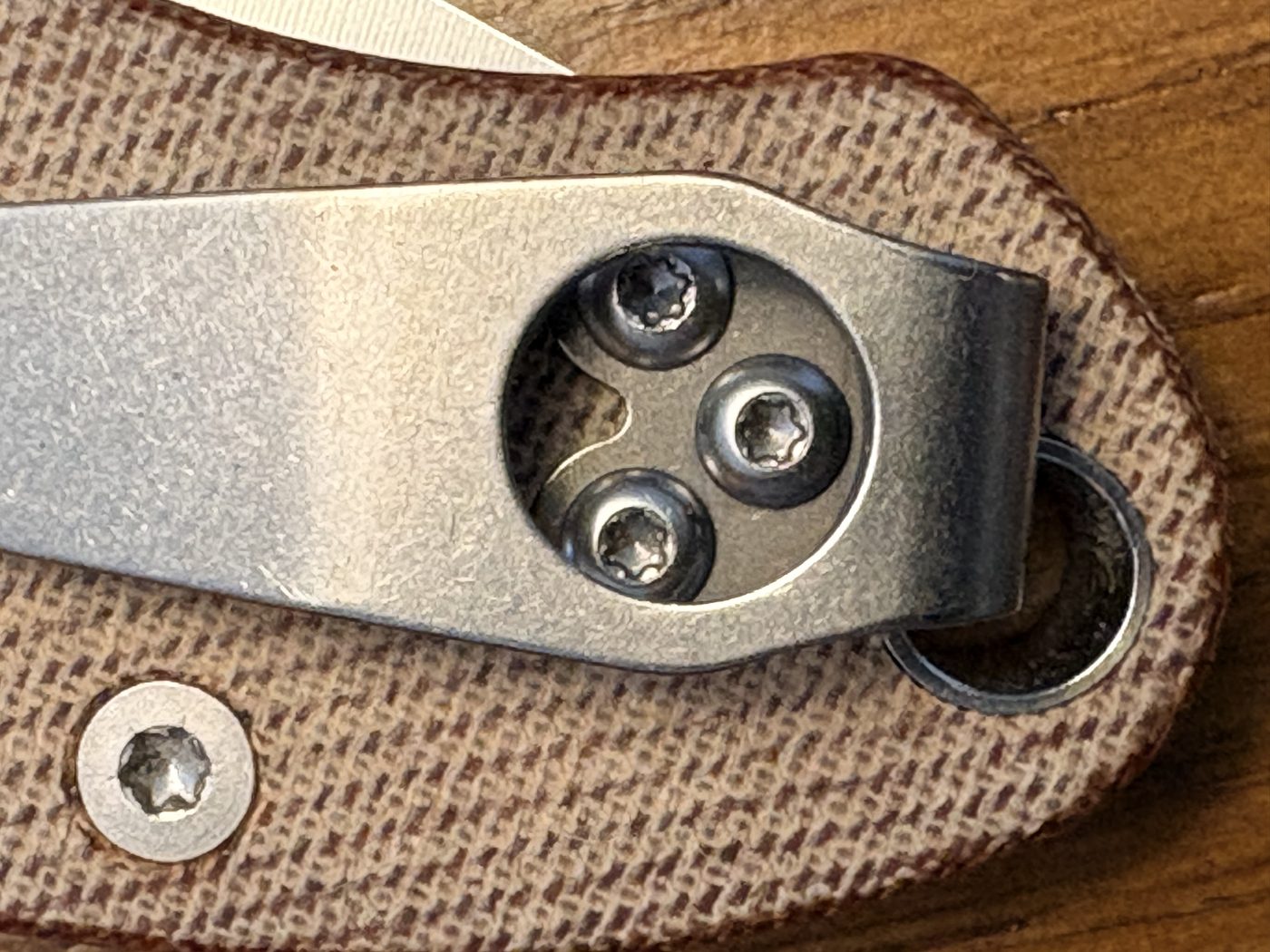 Knife clipped to the edge of a denim pocket