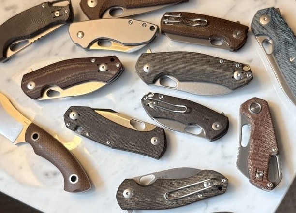 Voxnaes-designed knife collection spread on marble